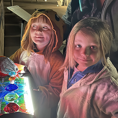 Kids enjoying playing with the laser controls for Laser Borealis